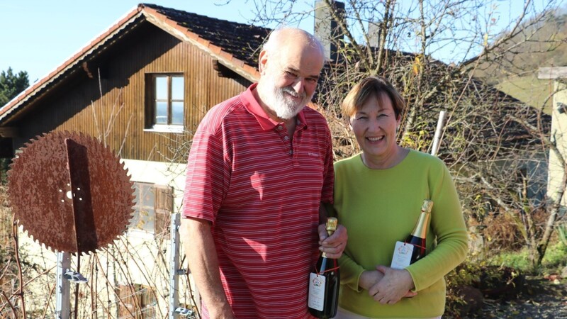 Franz und Doris Luttner mit ihrem Hobby-Produkt, dem 1. Baierwein Sekt, vor ihrem Haus in Tiefenthal.