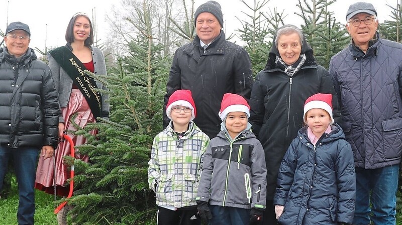 Einen der ersten Bäume konnten sich die Kinder vom Kindergarten St. Michael im Beisein der bayerische Christbaumkönigin Sophia Adlberger (3. von links) und Bürgermeister Christian Kiendl (3. von rechts) der aussuchen.