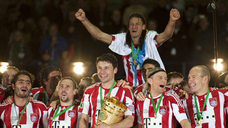 Mark van Bommel (M.) feiert den DFB-Pokalsieg 2010 - unter anderem mit Arjen Robben (re.).
