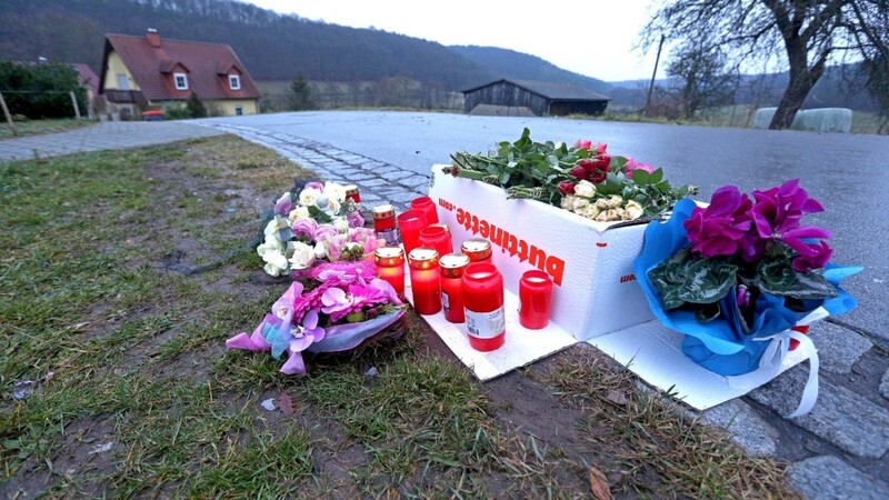 Blumen und Kerzen stehen am 02.01.2016 in Untersteinach in der Nähe von Oberaurach (Bayern) am Tatort. Eine Elfjährige wurde in der Silvesternacht vom Projektil einer Kleinkaliberwaffe getötet. Das durch einen Kopfschuss in Unterfranken tödlich verletzte elf Jahre alte Mädchen ist nun beigesetzt worden.