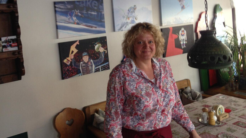 Martina Monath in ihrem Bistro in Garmisch-Partenkirchen: Startnummern und Fotos von Sohn Thomas hängen an der Wand.