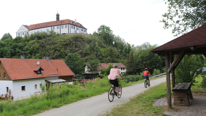 Zwei Radler auf dem Radweg mit Blick auf Schloss Altrandsberg.