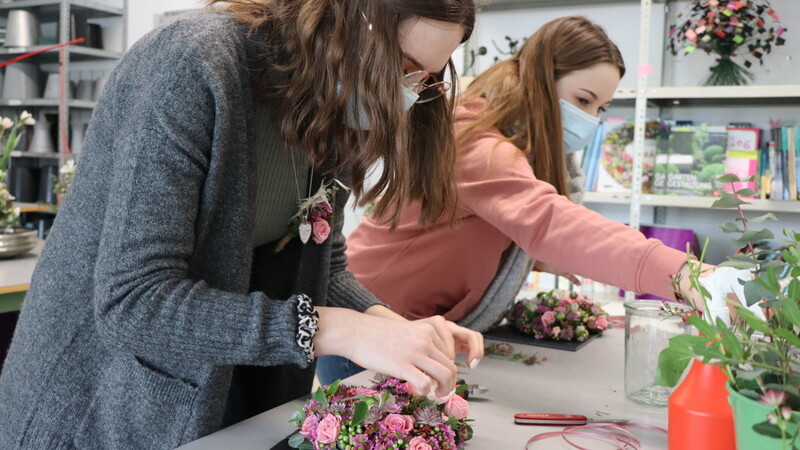 Floristik-Schülerinnen der Marianne-Rosenbaum-Schule arbeiten an gesteckten Herzen.