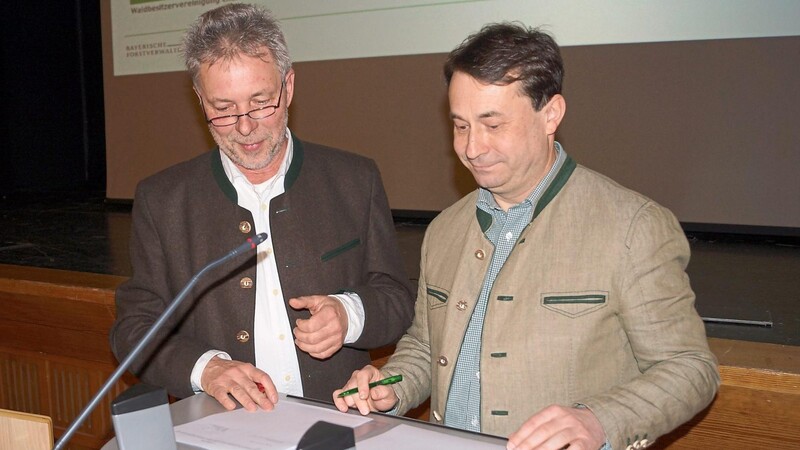 Forstdirektor Dr. Arthur Bauer (links) und Josef Ziegler unterzeichnen die Kooperationsvereinbarung.