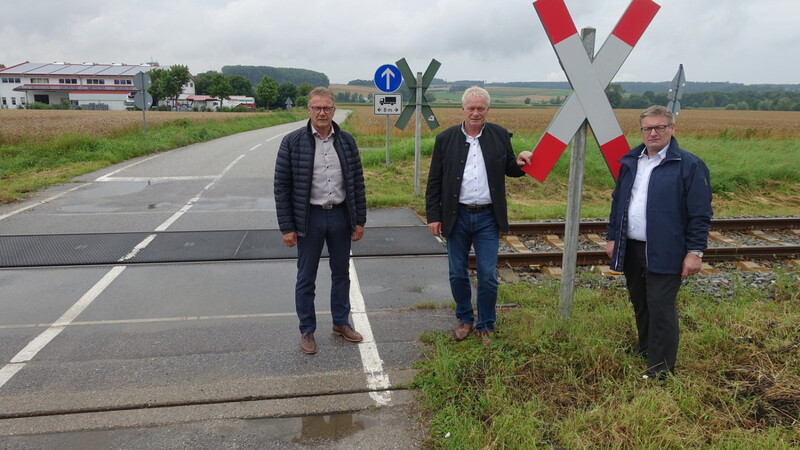 Bürgermeister Hans Grau, MdB Alois Rainer und MdL Josef Zellmeier (von links) am unbeschrankten Bahnübergang zum Gewerbegebiet.