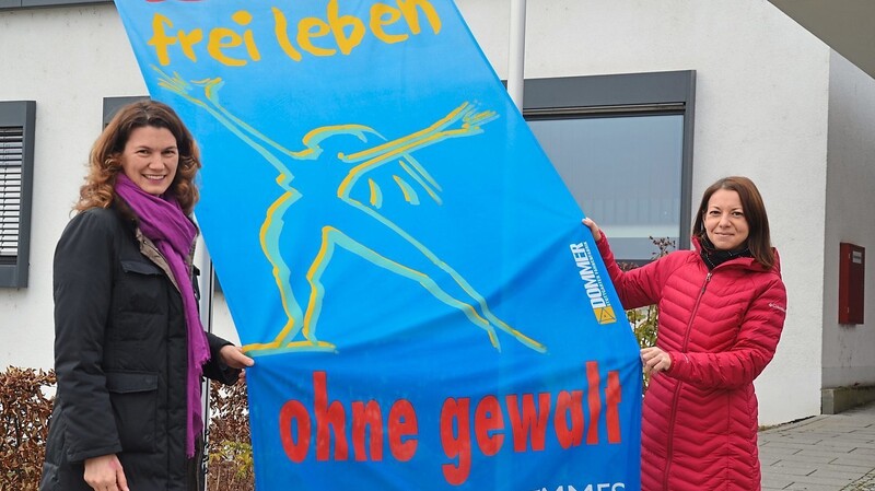 Landrätin Tanja Schweiger und die Gleichstellungsbeauftragte Silvia Siegler hissen die Fahne anlässlich des Tags gegen Gewalt an Frauen.