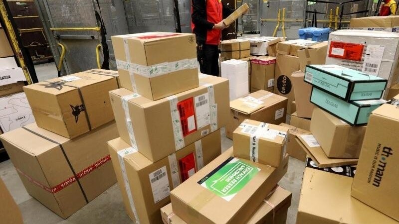 Pakete werden in einem Paketzentrum angeliefert und zur Verteilung weitergeleitet.