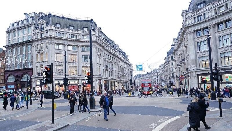 Menschen gehen über eine Kreuzung in London. Großbritannien wird ab Montag als Virusvariantengebiet eingestuft.