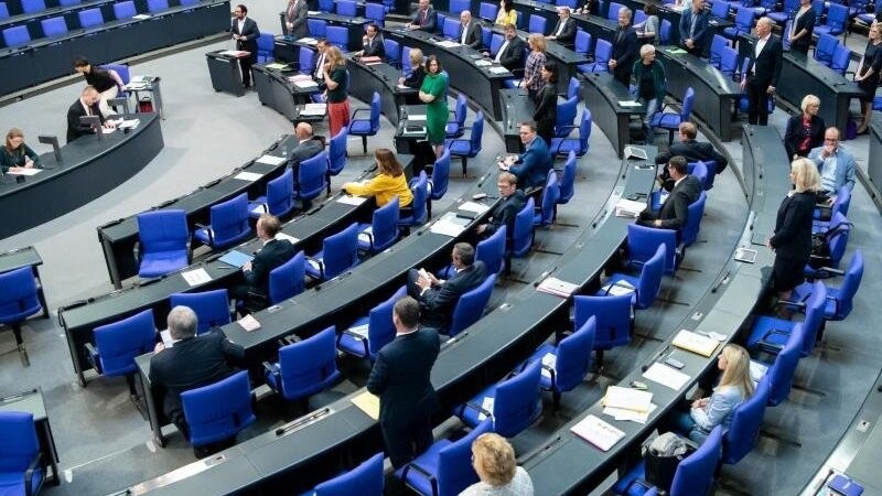 Abgeordnete stehen im Bundestag. Foto: Bernd von Jutrczenka/dpa/Archivbild