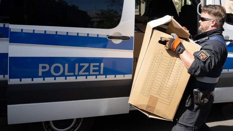 Ein Polizeibeamter entlädt am Landeskriminalamt Rheinland-Pfalz einen Transporter mit sichergestelltem Material aus einer Razzia in mehreren Bundesländern gegen die italienischen Mafia 'Ndrangheta.