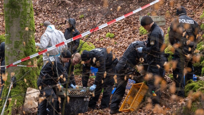 Im Wald bei Kipfenberg, dem Fundort der Leiche, sichern Polizisten in der Umgebung der Felsspalte Spuren