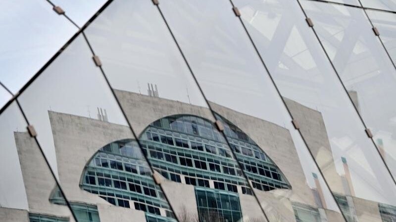 Das Bundeskanzleramt spiegelt sich in einer Glasfassade.