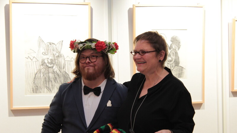 Zur Feier seiner Vernissage bekam Ludwig Hirtreiter von seiner "Entdeckerin" Renate Höning vom Atelier "Kunst inklusiv" einen Blumenkranz überreicht.