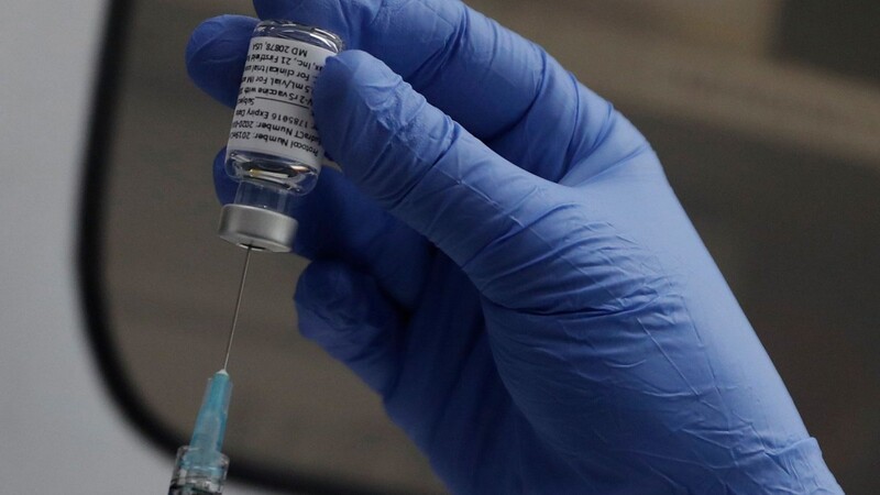 Ein medizinischer Mitarbeiter bereitet eine Impfung vor.