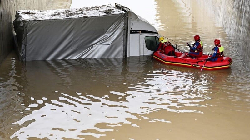 Einsatzkräfte der Wasserwacht in Saulgrub blicken Anfang Mai in einen Kleinlaster der überflutete Unterführung.