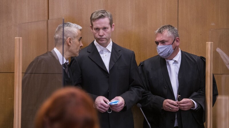 Stephan Ernst (M.), der des Mordes an Walter Lübcke angeklagt ist, spricht mit seinen Anwälten Mustafa Kaplan (l.) und Frank Hannig (r.) am ersten Prozesstag in Frankfurt.