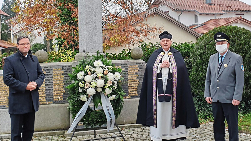 Bürgermeister Martin Panten, Pfarrer Richard Meier und Johann Häusler von der KSK bei der Kranzniederlegung.