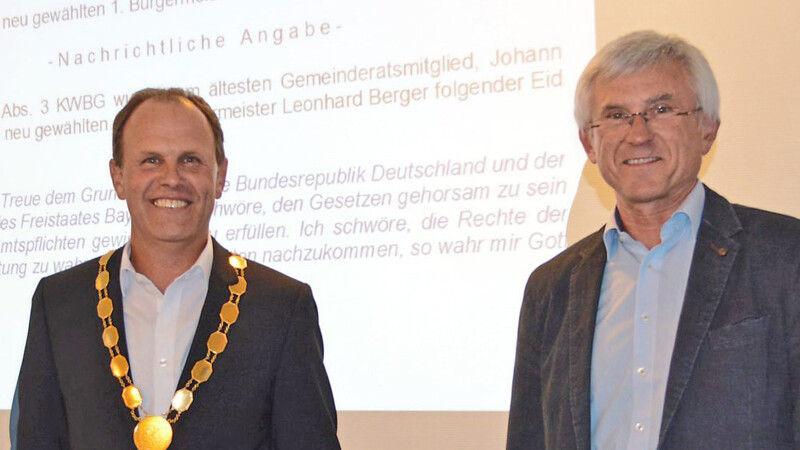 Johann Stanglmair (rechts) nahm als ältester Gemeinderat Bürgermeister Leonhard Berger den Amtseid ab und überreichte ihm die goldene Amtskette.