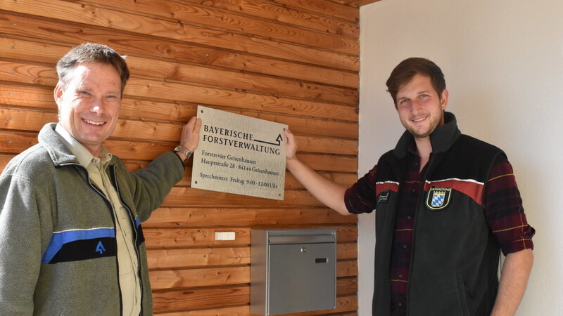 Er ist der neue Revierförster: Christoph Remböck (rechts), der das Hinweisschild mit seinem Chef Christian Kleiner schon einmal an die richtige Stelle an die Wand hält.