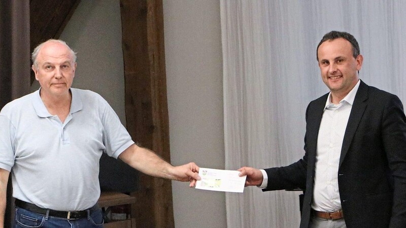 Ekkehard Hollschwandner (ÜWG, links) überreichte unter Applaus der Stadtratskollegen einen Scheck für die Ukraine-Hilfe an den Wörther Bürgermeister Josef Schütz (CSU).