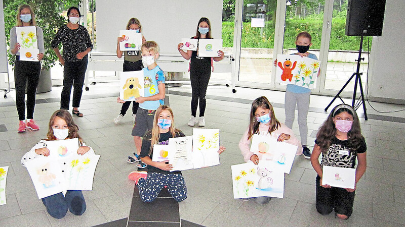 Malerin Raquel Solis (hinten 3. von links) gab den Mädchen und Buben beim Aquarellmalkurs viele Tipps und Tricks, sodass die Kinder viele kleine Kunstwerke aufs Papier zauberten und stolz präsentierten.