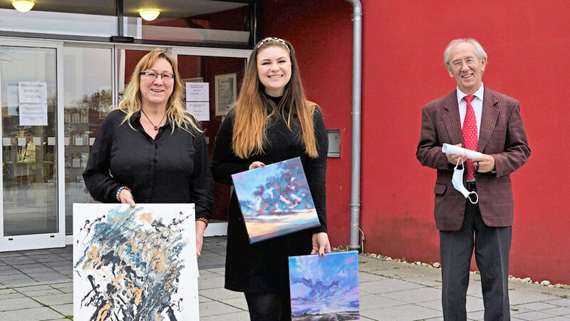 Ingrid und Melissa Faltermeier mit einigen ihrer Bilder aus der aktuellen Ausstellung mit Wilhelm Lindinger, Vorsitzender der Freunde und Förderer der Klinik Bogen (von links).