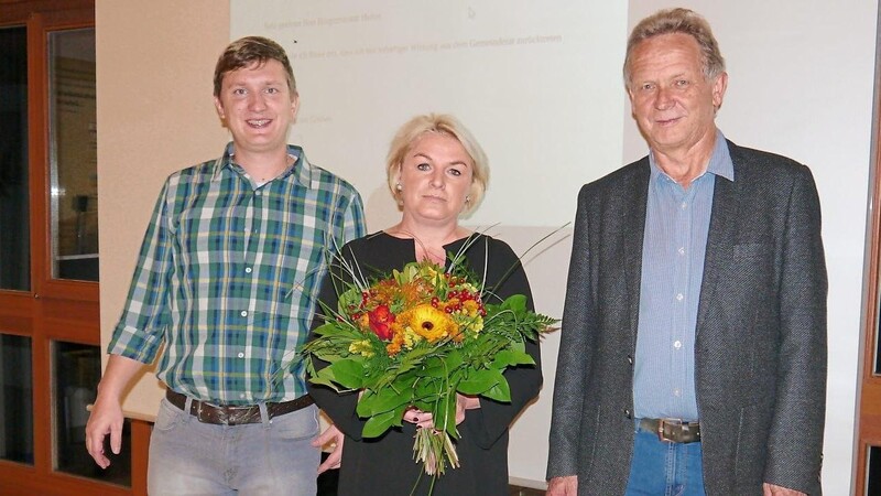 Dritter Bürgermeister Rudolf Hohlneicher (re.) und Gemeinderat Daniel Wühr (li.) verabschieden ihre Ratskollegin Evelyn Barth mit einem Blumenstrauß aus dem Gemeinderat.