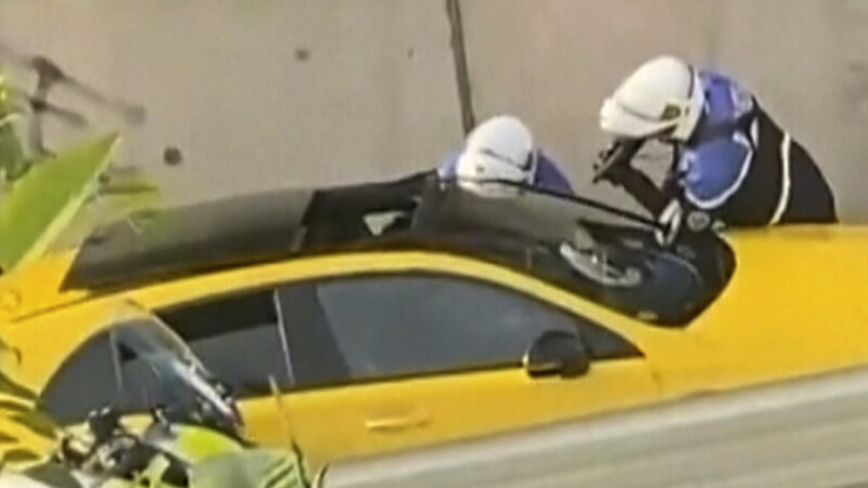 In diesem von Ohana_FNG zur Verfügung gestellten Videostandbild befragen zwei Polizeibeamte einen Fahrer, wobei ein Polizist eine Waffe auf das Fenster des gelben Autos richtet. Nach einem tödlichen Polizeischuss auf einen 17-Jährigen bei einer Verkehrskontrolle ist Frankreich in Aufruhr.