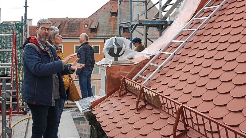 Projektleiter Christian Piwonka erklärt die Sanierungsmaßnahme am Haus. Das Dach des historischen Gebäudes wird mit Biberschwanzziegeln neu eingedeckt.