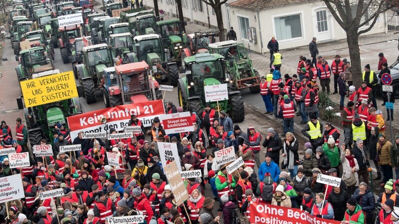 Rund 3 000 Anwohner mit etwa 150 Traktoren aus dem Landkreis Rosenheim demonstrierten vor dem Landratsamt mit Plakaten gegen die Pläne zum Bau einer neuen Bahntrasse durch das Inntal.