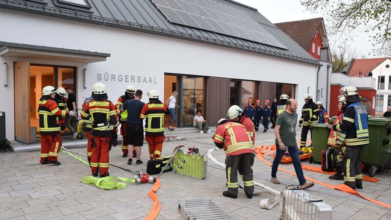 Buntes Durcheinander am Rathausplatz: Festausschussmitglieder und Vereinsvertreter sowie ankommende Gemeinderäte zwischen den Feuerwehrleuten.