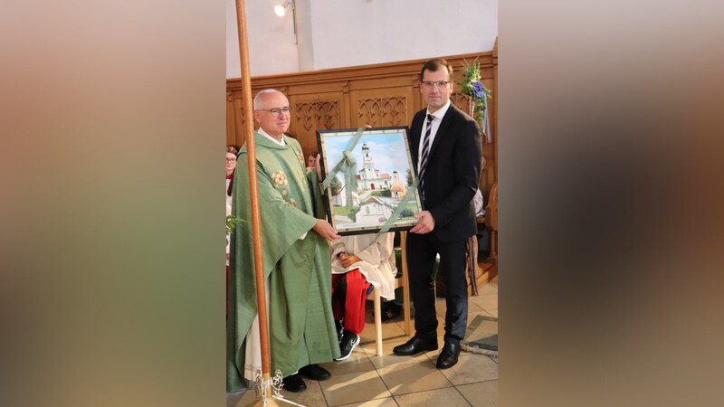 Bürgermeister Hans-Jürgen Fischer überreichte ein Ölgemälde mit den Kirchen der Gemeinde.