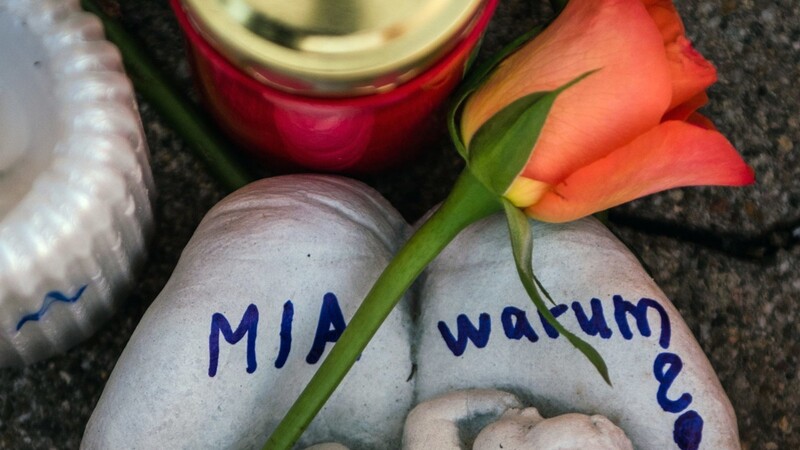 Zwei Handflächen mit der Aufschrift "Mia warum?" und eine Rose liegen am 28.12.2017 vor dem Drogeriemarkt in Kandel (Rheinland-Pfalz). Nach Aussage der Staatsanwaltschaft Landau und des Polizeipräsidiums Rheinpfalz hat ein 15 Jahre alter Afghane in Kandel ein gleichaltriges deutsches Mädchen erstochen.