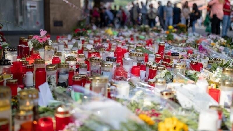 Grablichter, Kerzen und Blumen liegen vor einem Kaufhaus in der Innenstadt, in dem ein Mann vor einer Woche Menschen mit einem Messer attackiert und getötet hatte.