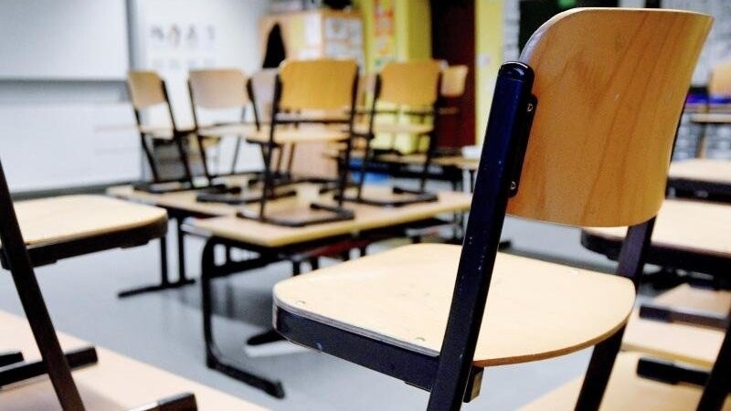 Stühle stehen in einem Klassenzimmer in einer Grundschule auf den Tischen. Foto: Caroline Seidel/dpa/Archiv