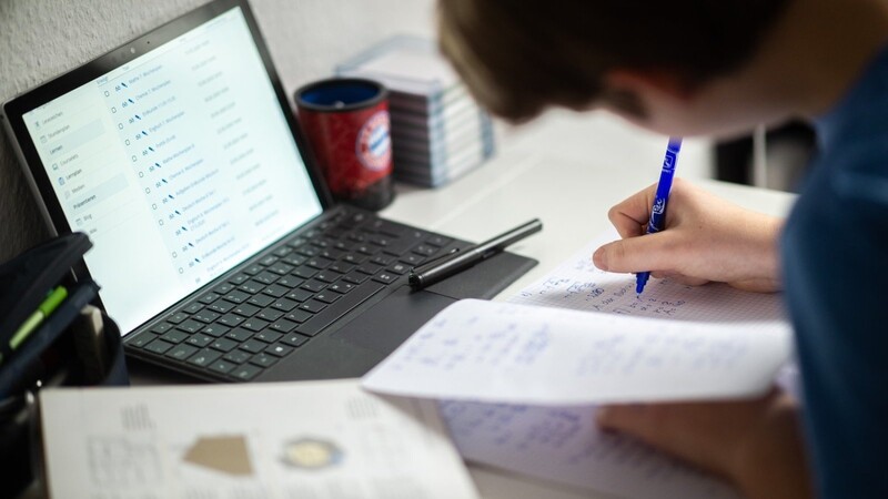 Ein Schüler sitzt in seinem Zimmer am Schreibtisch und erledigt Aufgaben im Rahmen des Homeschoolings: Viele sind auf digitale Leihgeräte der Schulen angewiesen.