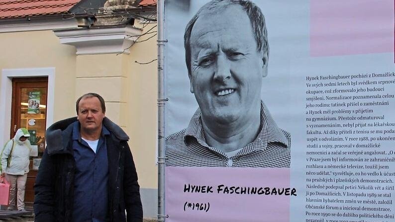 Hynek Faschingbauer neben Transparenten in Doma?lice, die derzeit an die Samtene Revolution erinnern.