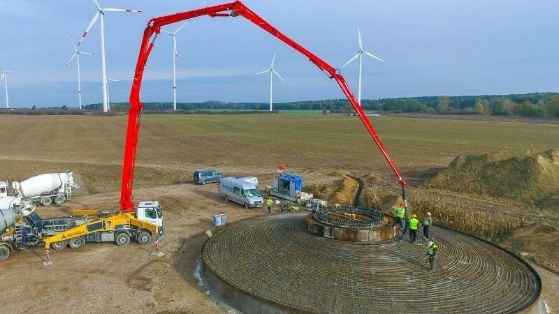 Arbeiter betonieren das Fundament einer Windenergieanlage im Landkreis Oder-Spree.