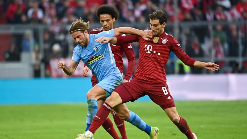 Freiburgs Lucas Höler (l.) kämpft um den Ball mit Münchens Leroy Sane (hinten) und Münchens Leon Goretzka (r.). (Symbolbild)