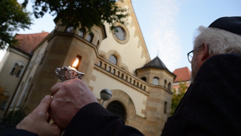Pfarrer Hasso von Winning mit einer Kerze vor der Synagoge im Oktober 2019, als mehr als 400 Straubinger der Opfer des Anschlags von Hanau gedachten.
