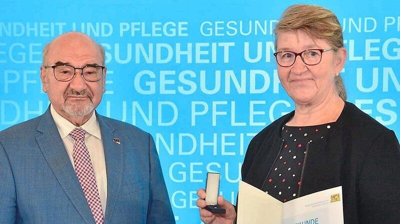 Im Auftrag von Gesundheitsminister Klaus Holetschek überreite Prof. Dr. Peter Bauer an Marga Löffler die Auszeichnung "Weißer Engel".