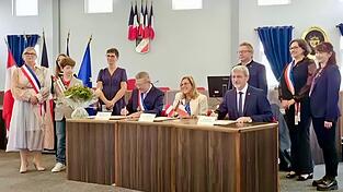 Der feierliche Akt im Rathaus von Ludres: Die seit 40 Jahren bestehende Partnerschaft zwischen den beiden St&auml;dten wird durch eine erneute Urkundenunterzeichnung durch die beiden B&uuml;rgermeister und Anne Morel best&auml;rkt.