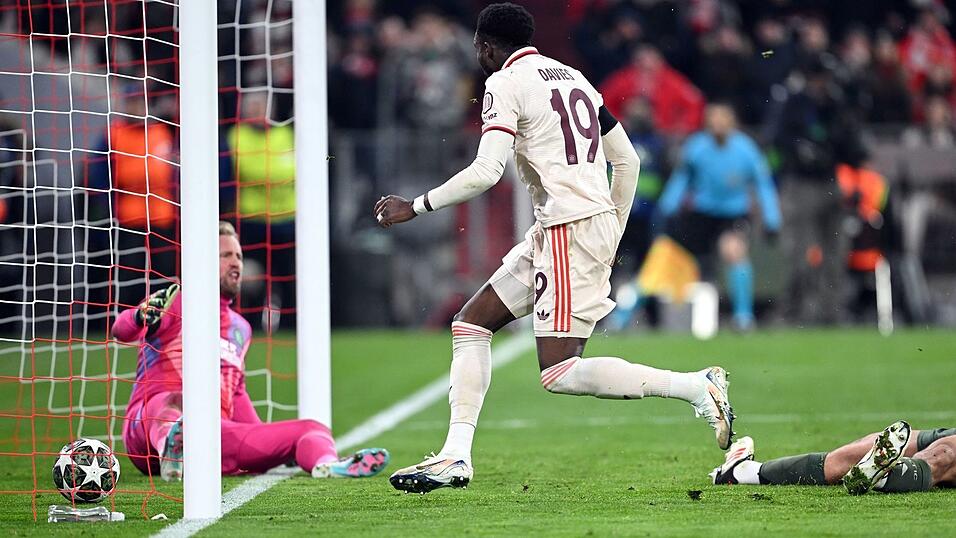 Alphonso Davies stochert den Ball ins Tor, am Boden Celtic-Torwart Kasper Schmeichel (l).
