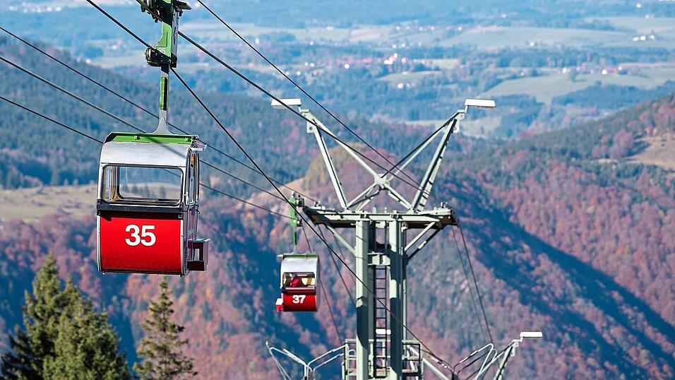 Gondeln der Kampenwandbahn fahren zur Berg- beziehungsweise Talstation. Das Landratsamt Rosenheim genehmigte die Pläne für die neue Seilbahn bereits 2017. Eine Online-Petition mit über 7 000 Unterstützern sorgte dann für Widerstand gegen das Projekt. Gondeln der Kampenwandbahn fahren zur Berg- beziehungsweise Talstation. Das Landratsamt Rosenheim genehmigte die Pläne für die neue Seilbahn bereits 2017. Eine Online-Petition mit über 7 000 Unterstützern sorgte dann für Widerstand gegen das Projekt.