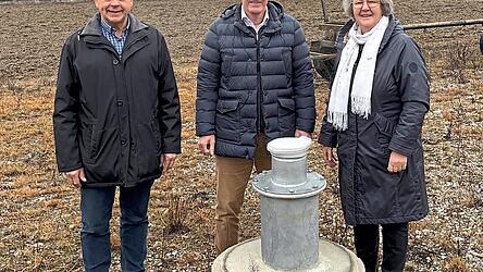 Stellvertretender Verbandsvorsitzender Konrad Hartshauser, Gesch&auml;ftsleiter Jochen Ammer und Verbandsvorsitzende Luise Hausberger vor der Versuchsbohrung in Hofham. Im Hintergrund ist das Wasserwerk des Zweckverbands Isar-Vils zu sehen.