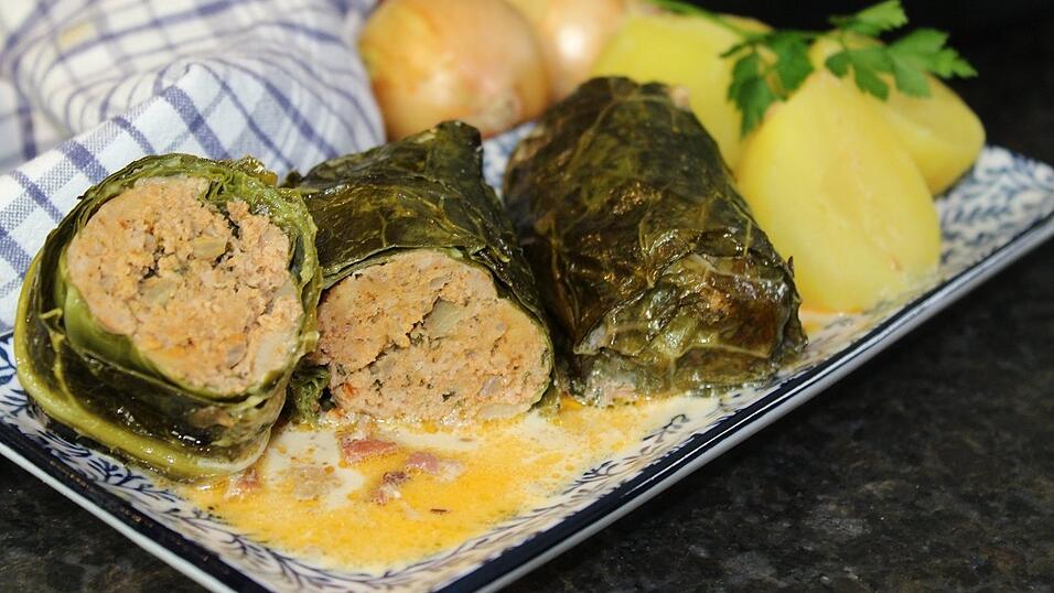 Das sind geschmorte Kohlrouladen gefüllt mit Hack. Prinzipiell eignet sich jede Kohlsorte, die große Blätter besitzt, um damit vernünftig das Hackfleisch einwickeln zu können.