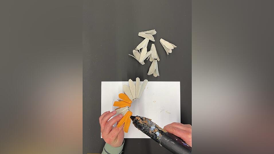 Mit einer Hei&szlig;klebepistole befestigst du die Bl&uuml;tenbl&auml;tter.