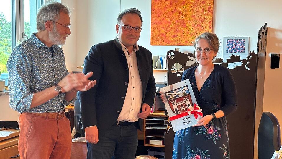 Bürgermeister Martin Stoiber (Mitte) überreicht ein Stadtwappen an Dr. Franz Bauer und Viktoria Guralnik.