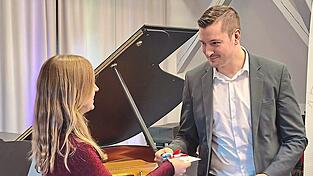 Als kleines Dankesch&ouml;n &uuml;berreicht ihr Landrat Christian Schindler einen Kinogutschein.
