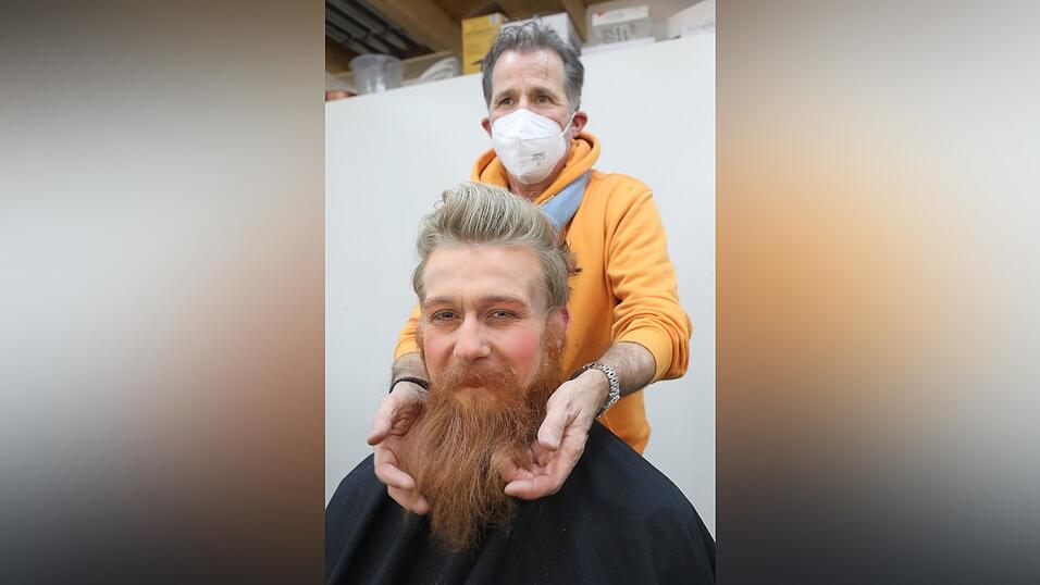 Zwischen Oberlippe und Nase klebt er einen zotteligen Schnauzer.